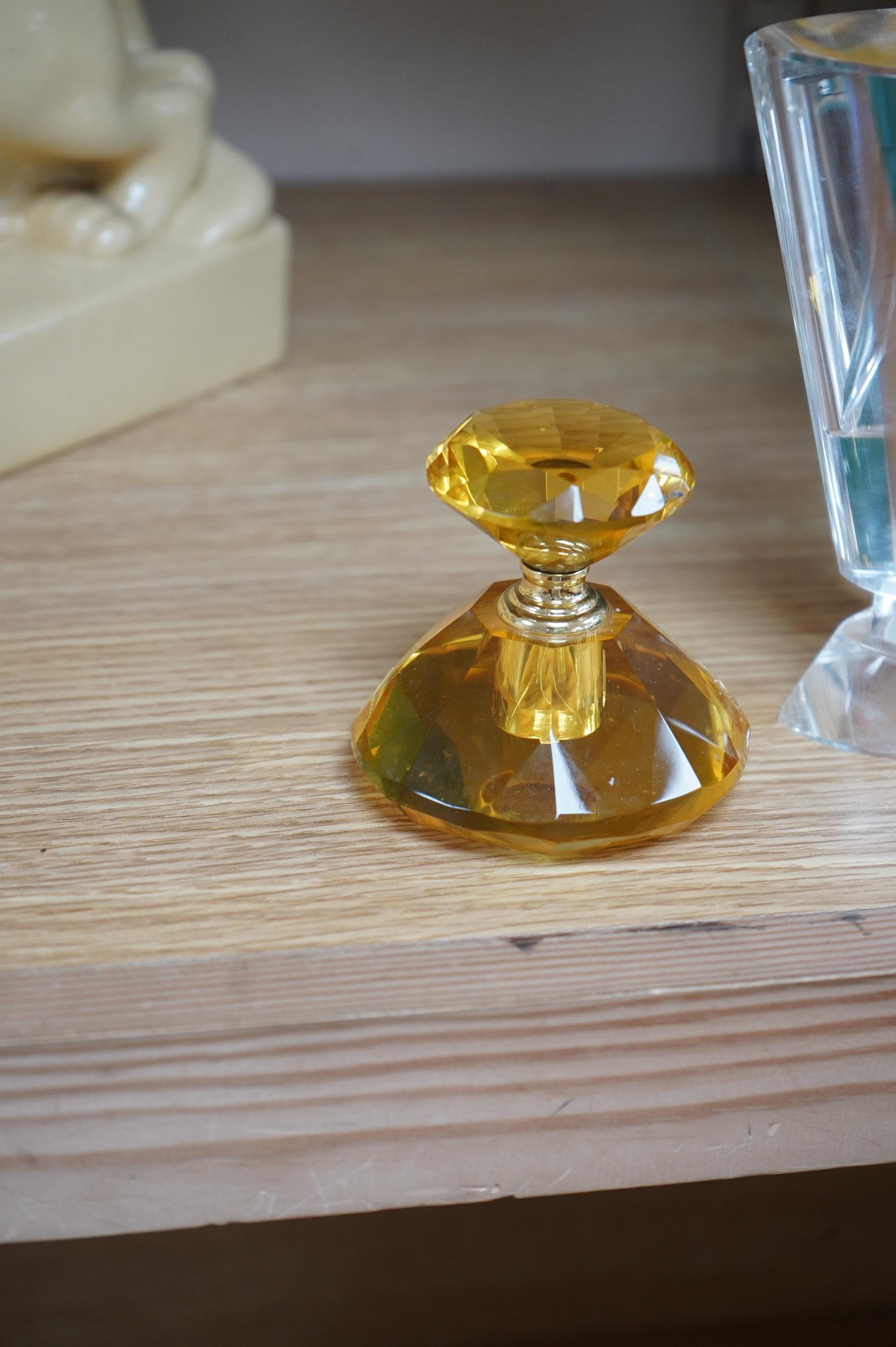 An amber glass perfume bottle and an oversized Art Deco style glass perfume bottle